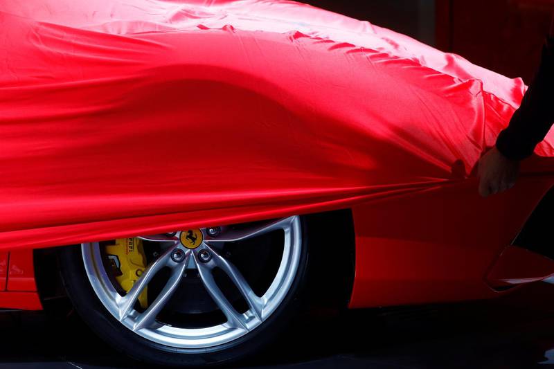 FILE PHOTO: A partially covered Ferrari car is pictured before the opening of the Frankfurt Motor Show (IAA) in Frankfurt, Germany September 11, 2017. REUTERS/Kai Pfaffenbach/File Photo