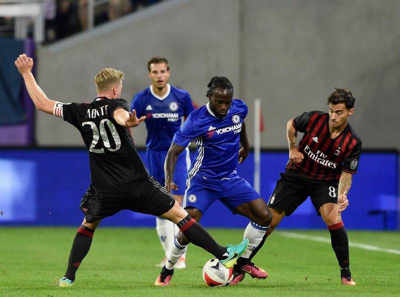 Chelsea winger Victor Moses controls the ball against Ignazio Abate and Fernandez Jesus of AC Milan. Hannah Foslien / Getty Images