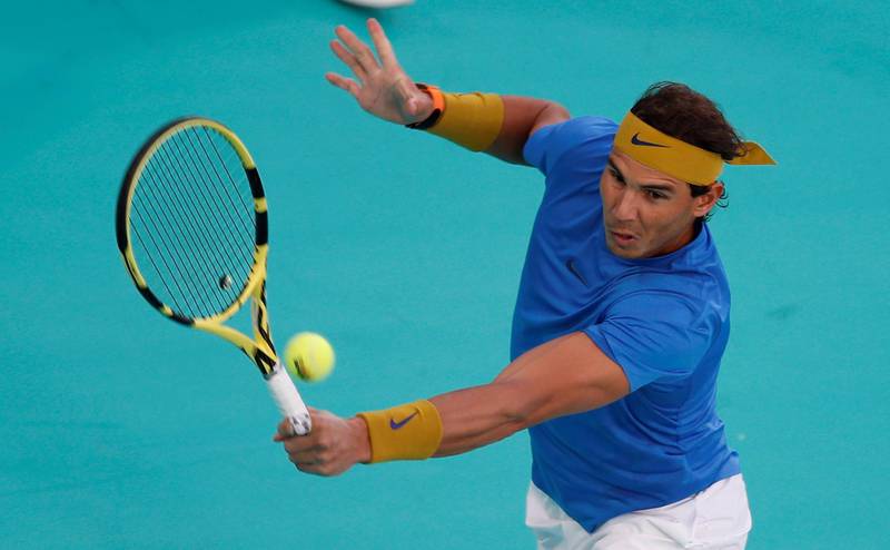 Rafael Nadal returns a ball to Kevin Anderson during their Mubadala World Tennis Championship semi-final in Abu Dhabi. EPA