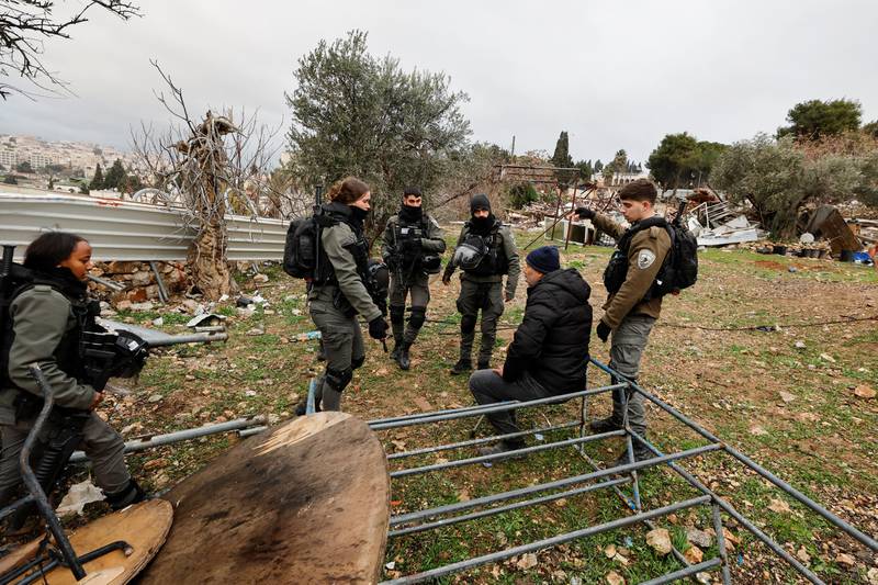 Members of the Israeli border police speak with a Palestinian man at the site of the demolished house. Reuters