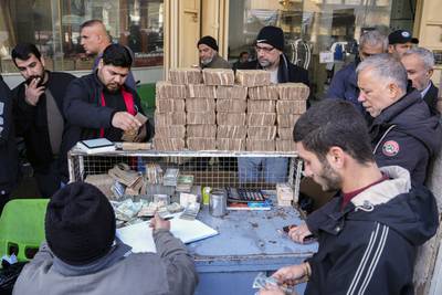 Citizens exchange US dollars in Shurja market in central Baghdad. AP