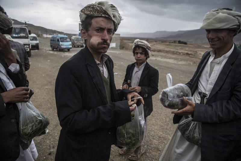Yemeni men selling qat on the highway between Amran and Hajja governorates, both areas dominated by Houthi rebels, northern Yemen. Qat is a green leaf from a plant that is chewed on and used as a mild stimulant. Asmaa Waguih/EPA