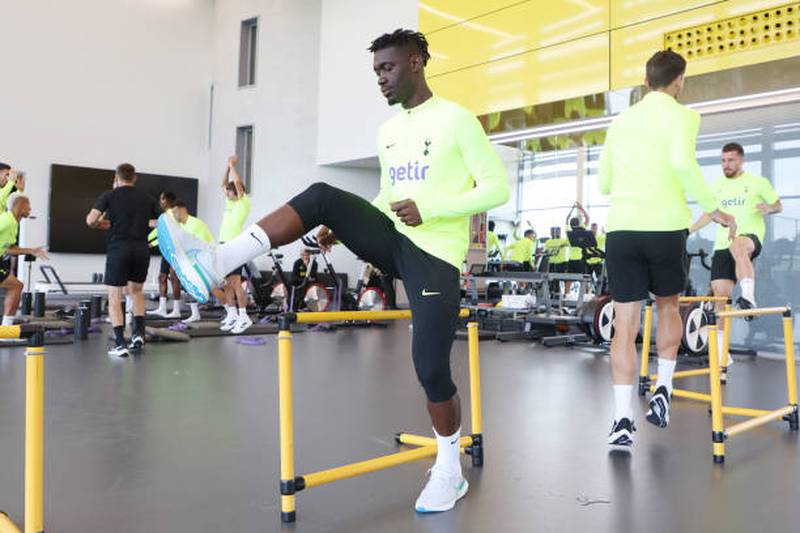 Yves Bissouma of Tottenham Hotspur takes part in stretching exercises. Getty Images