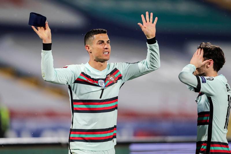 epa09102262 Portugal's Cristiano Ronaldo (L) and Bernardo Silva (R) react during the Group A of FIFA World Cup Qatar 2022 qualifier match at Rajko Mitic Stadium in Belgrade, Serbia, 27th March 2021.  EPA/MIGUEL A. LOPES