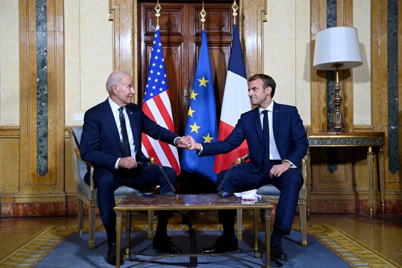 Mr Macron, right, and Mr Biden meet at the French Embassy to the Vatican in Rome on October 29, 2021
