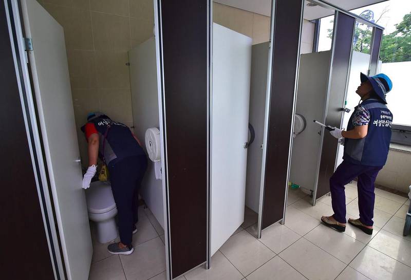 Members of Seoul’s ‘hidden camera-hunting’ squad inspecting a women’s bathroom stall to find secret cameras. South Korea takes pride in its tech prowess, from ultra-fast broadband to Samsung’s cutting-edge smartphones. But it’s a culture that has also given rise to an army of tech-savvy peeping Toms in a still male-dominated country with a poor record on women’s rights. Jun Yeon-je / AFP