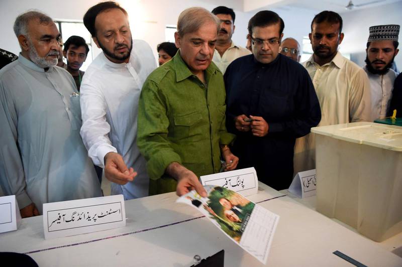 Shabaz Sharif shows his ballot papers as he casts his vote in Lahore. AFP