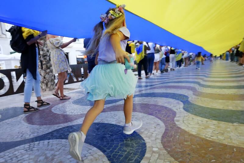 Ukrainians in Alicante, Spain, display a 100-metre national flag during a demonstration in solidarity with the people of Ukrainian cities shelled by Russian forces. EPA