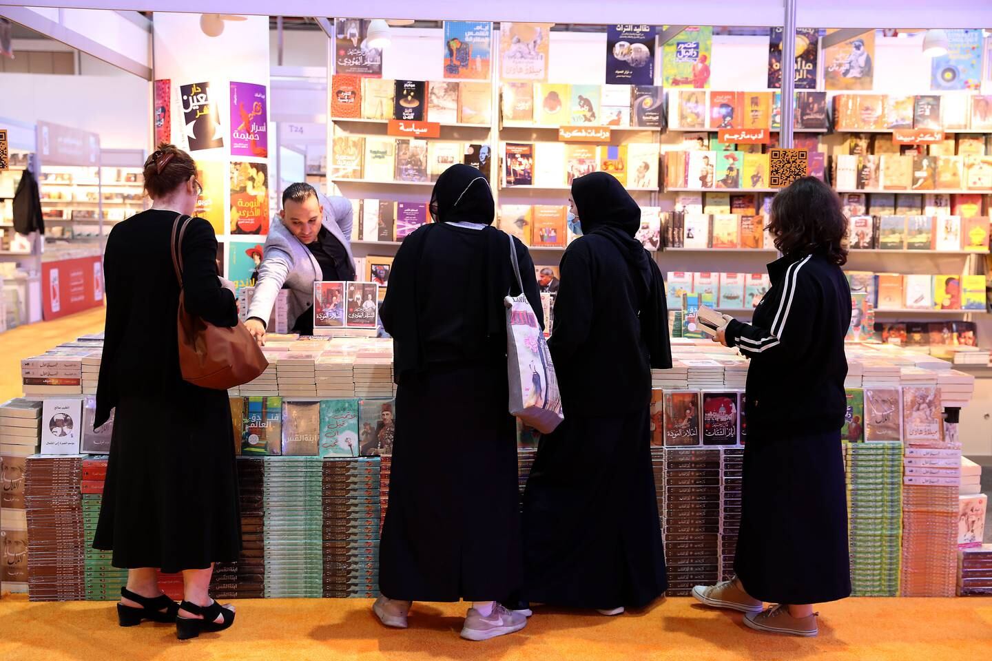 Visitors browsing books on the first day of the Sharjah International Book fair held at Expo centre in Sharjah. Pawan Singh / The National