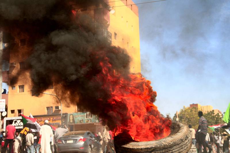 Protesters burn tyres at the scene of confrontations with security forces.  AFP
