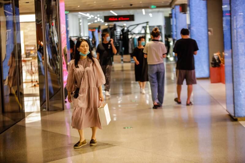 Shoppers at a mall in Beijing's Central Business District area. The pandemic situation in China is still 'severe and complex', and the negative impact of coronavirus controls on the economy is still pronounced. EPA