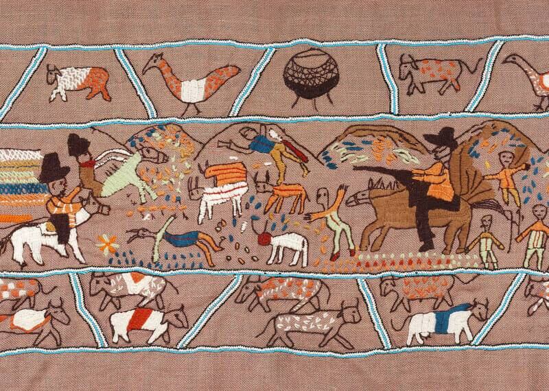 A scene showing European settlers killing people and cattle on the Keiskamma Tapestry, which sits in the South African Parliament building, where a fire has put the artistic masterpiece in danger. All photos: Keiskamma Trust