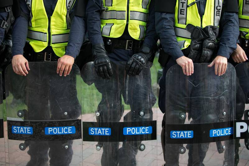 Virginia State Troopers stand down during a rally on the campus of The University of Virginia one-year after the violent white nationalist rally that left one person dead and dozens injured, in Charlottesville, Virginia on August 11, 2018. - US President Donald Trump, often accused of denigrating non-white people, condemned racism Saturday as the nation marked the anniversary of deadly unrest triggered by a neo-Nazi rally in Charlottesville, Virginia. That protest left one person dead and highlighted the growing boldness of the far right under Trump. Another far-right rally is scheduled for Sunday, right outside the White House. (Photo by Logan Cyrus / AFP)