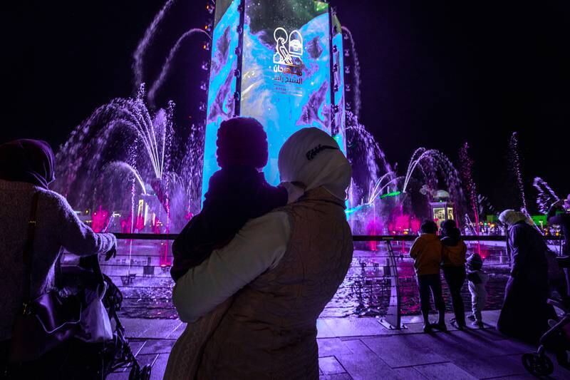 Visitors view a light display at Sheikh Zayed Heritage Festival. Victor Besa / The National