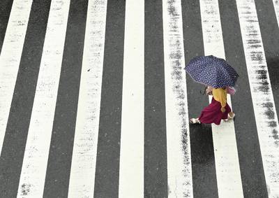 A woman walks in the rain at a pedestrian crossing near Osaka Station as Typhoon Hagibis approaches Osaka, Japan. Reuters
