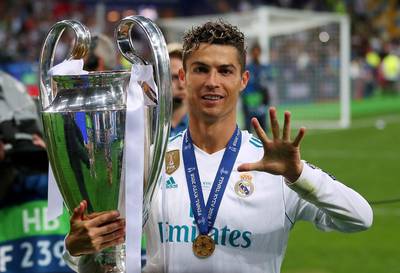 Real Madrid's Cristiano Ronaldo holds up five fingers representing his five Champions League wins. Hannah McKay / Reuters
