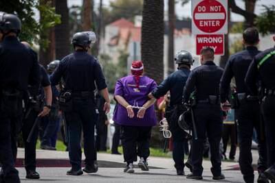 A healthcare worker is arrested by police after they refused to move while demonstrating with a sit-in during a Labor Day rally gathering hundreds of healthcare workers in front of Kaiser Permanente Los Angeles Medical Center. EPA