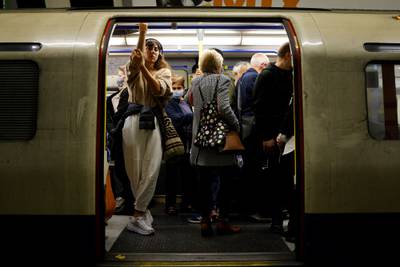 Commuters wait for an underground train to leave from a tube stop in central London. Data up to Sunday showed more than 300,000 confirmed cases reported over the last seven days, a 15 percent increase in cases on the previous week. AFP