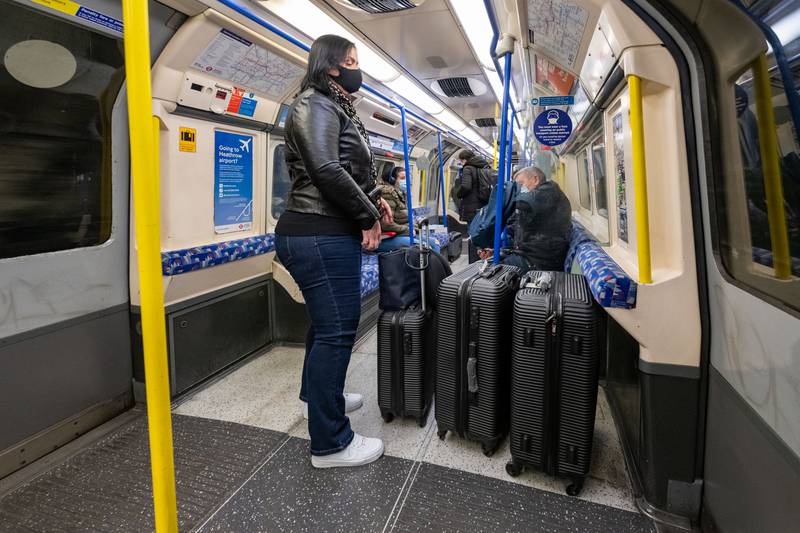 A woman uses a London Underground train to get to Heathrow Airport, which will be hit by transport disruption over the Christmas period. Getty Images