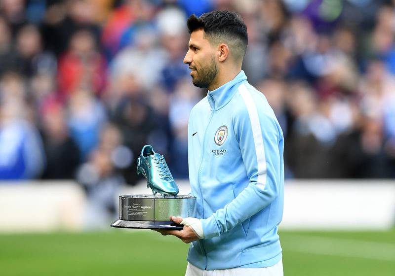 Manchester City's Argentinian striker Sergio Aguero is awarded a trophy for being Manchester City's all-time leading goal scorer, ahead of the English Premier League football match between Manchester City and Arsenal at the Etihad Stadium in Manchester, north west England, on November 5, 2017. - Aguero became the City's leading goalscorer when he scored the third goal in City's 4-2 UEFA Champions League victory against Napoli on November 1. His 69th minute strike was his 178th in 264 appearances for the club. (Photo by Paul ELLIS / AFP) / RESTRICTED TO EDITORIAL USE. No use with unauthorized audio, video, data, fixture lists, club/league logos or 'live' services. Online in-match use limited to 75 images, no video emulation. No use in betting, games or single club/league/player publications. / 