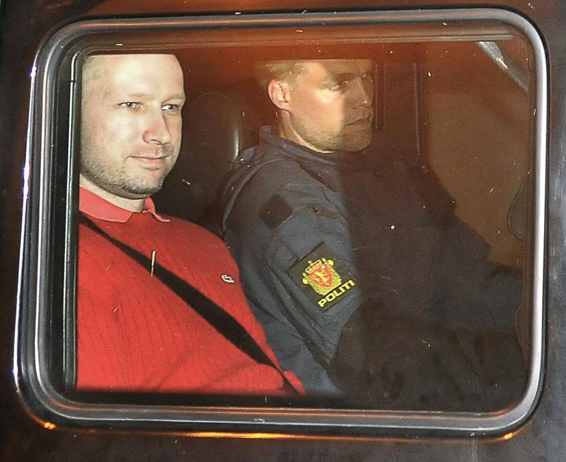 Bomb and terror suspect Anders Behring Breivik (red top) leaves the courthouse  in a police car  in Oslo on July 25, 2011, after the hearing to decide his further detention.  Breivik will be held in solitary confinement for the first four weeks, with a ban on all communication with the outside world in a bid to aid a police investigation into his acts.
AFP Photo Jon-Are Berg-Jacobsen / Aftenposten
 *** Local Caption ***  490497-01-08.jpg
