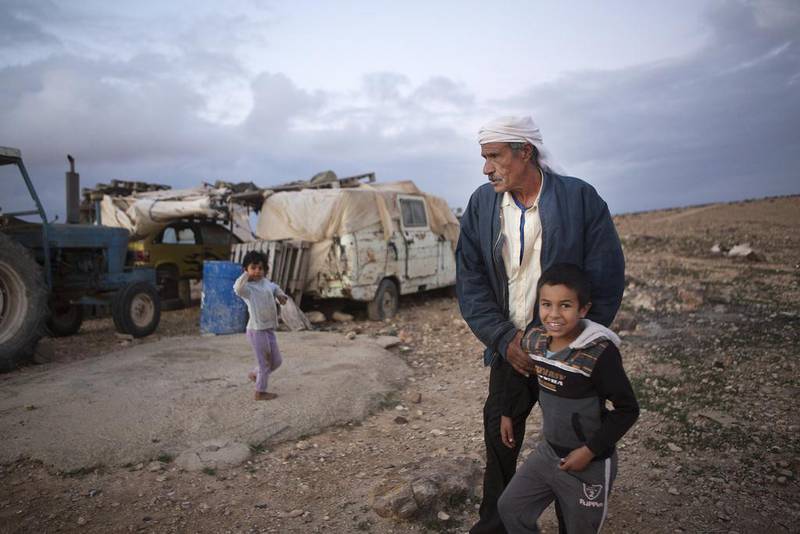 Salameh Gwineh, 64, with his children near his home in the village of Qatamat located in the Negev Desert south of Israeli city of Beersheba. The Israeli government has plans to build a Jewish community called Daya but Gwineh says, ‘I want to stay where I live, this is my place.’ Photo by Heidi Levine for The National

