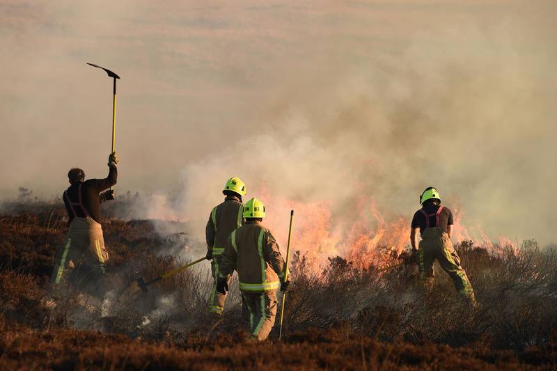 Firefighters tackle a blaze on moorland above Marsden. AFP