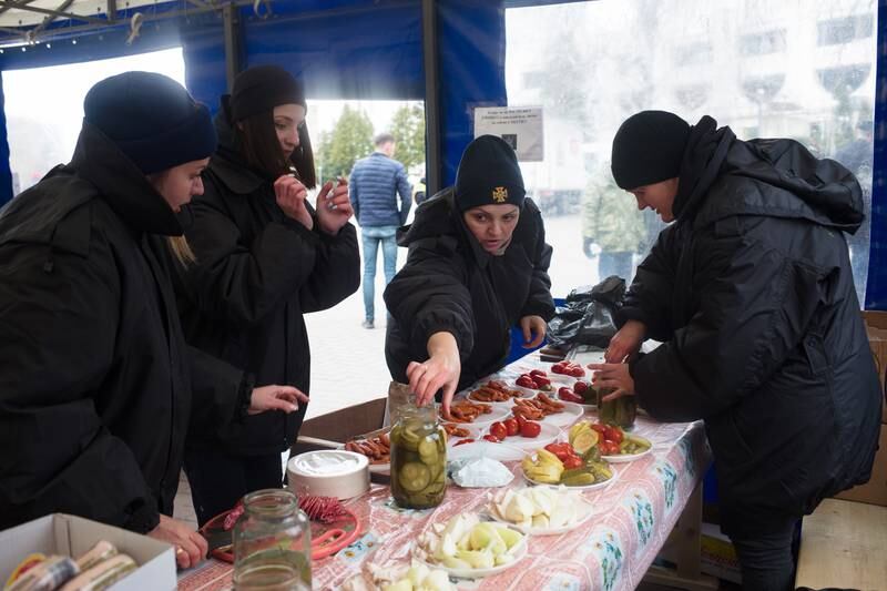 Rescue workers make lunch in a tent on Wednesday in Borodyanka, Ukraine. The country’s fiscal gap is expected to reach between $3bn and $10bn a month because of the war. Getty