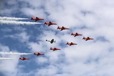 Britain's Red Arrows fly in formation around a Spitfire at the Farnborough Airshow in 2018.