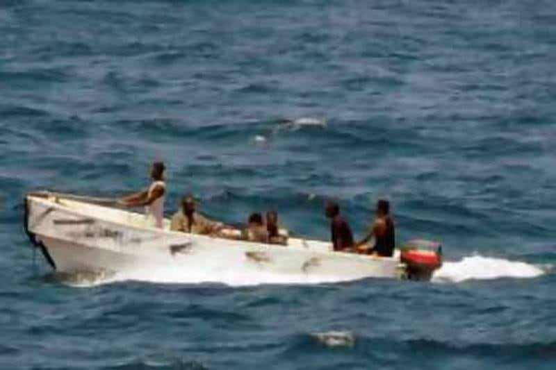 This handout photo provided by the US Navy on October 9, 2008 shows some of the Somali pirates who held the Belize-flagged Ukrainian cargo MV Faina transit to shore while under observation by a US Navy ship, off of Somalia's coast as seen from a US Navy ship on October 8, 2008. The US Navy stood guard on September 30 around the ship carrying tanks and arms to stop them from falling into the wrong hands in lawless Somalia amid growing confusion over the cargo's destination. The ship was seized by Somali pirates on September 25 in the Indian Ocean on its way to the Kenyan port of Mombasa. The pirates have demanded 20 million US dollars to free the ship, its cargo and crew of 21 consisting of Ukrainians, Russians and Latvians. AFP PHOTO/HO/US NAVY/Jason R. Zalasky
  = RESTRICTED TO EDITORIAL USE = GETTY OUT= *** Local Caption ***  445384-01-08.jpg