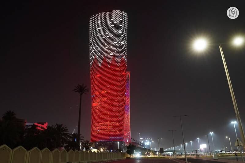Adnec's Capital Gate building in Abu Dhabi is lit up with the colours and design of the Bahrain flag.