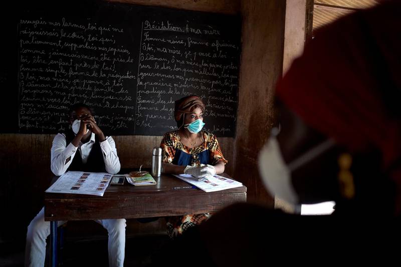 Electoral officials wear masks and gloves as a preventive measure against the spread of the COVID-19 coronavirus during the parliamentary elections in Bamako.  AFP
