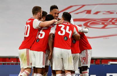 Aubameyang and teammates celebrate the second. AP
