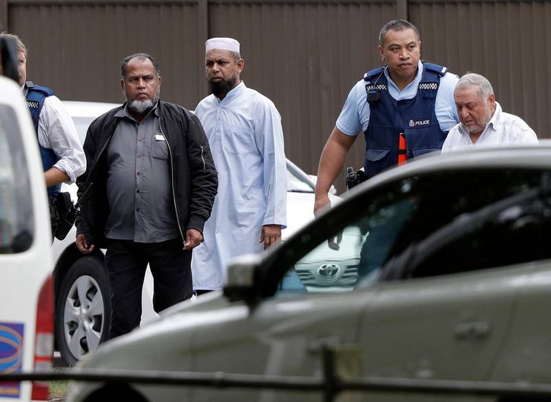 Police escort men from the mosque in central Christchurch where dozens of people were feared dead after a shooting. AP Photo
