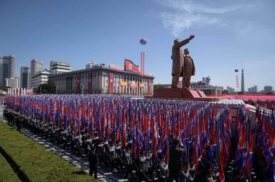 Students march past a balcony from where North Korea's leader Kim Jong Un was watching, during a mass rally on Kim Il Sung square in Pyongyang.  AFP