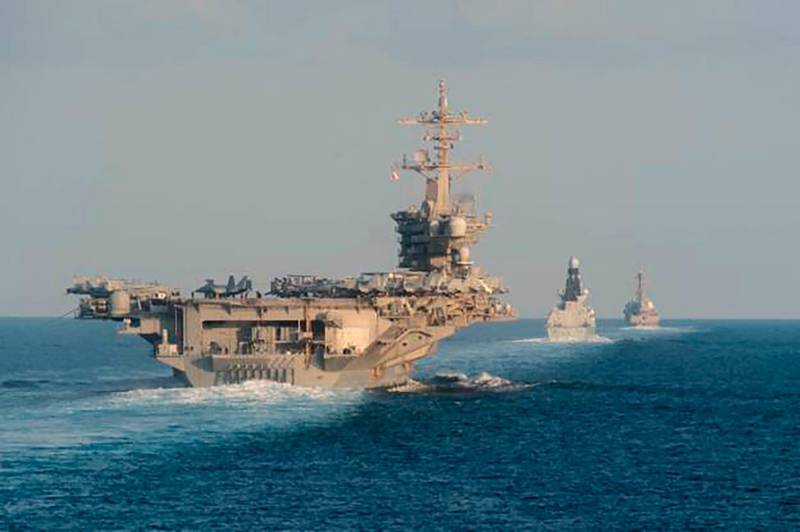 In this Tuesday, Nov. 19, 2019, photo made available by U.S. Navy, the aircraft carrier USS Abraham Lincoln, left, the air-defense destroyer HMS Defender and the guided-missile destroyer USS Farragut transit the Strait of Hormuz with the guided-missile cruiser USS Leyte Gulf. The U.S. aircraft carrier Abraham Lincoln sent to the Mideast in May over tensions with Iran transited the narrow Strait of Hormuz for the first time on Tuesday. The ship previously had been in the Arabian Sea outside of the Persian Gulf. (Mass Communication Specialist 3rd Class Zachary Pearson/U.S. Navy via AP)