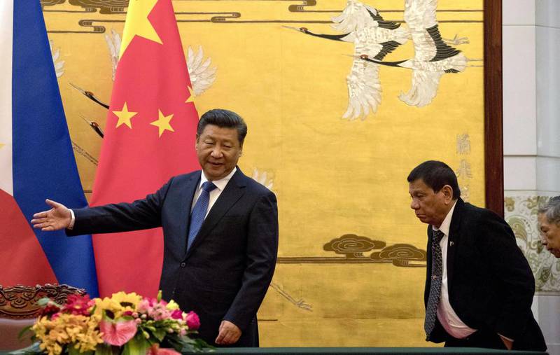 Philippines President Rodrigo Duterte, right, has attempted to get closer to his Chinese counterpart Xi Jinping. AP Photo