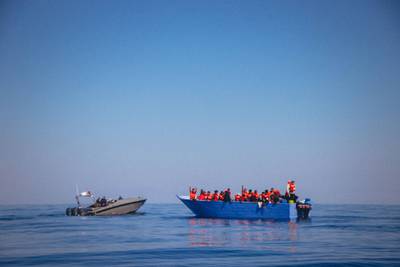 A handout picture released by German migrant rescue NGO Sea-Eye and taken on April 6, 2020, reportedly shows a speed boat of Libyan authorities around a small boat in distress off the Libyan coast during a rescue operation with the NGO vessel "Alan Kurdi". - German NGO Sea Eye said it had saved 150 people from small boats in distress off the Libyan coast, while adding that European nations had already refused to allow rescued migrants to land. Sea Eye ship Alan Kurdi pulled 68 people from the Mediterranean in the morning before picking up dozens more later, the group said in a statement. (Photo by Cedric FETTOUCHE / various sources / AFP) / RESTRICTED TO EDITORIAL USE - MANDATORY CREDIT "AFP PHOTO /SEA-EYE.ORG / Cedric FETTOUCHE " - NO MARKETING NO ADVERTISING CAMPAIGNS - DISTRIBUTED AS A SERVICE TO CLIENTS