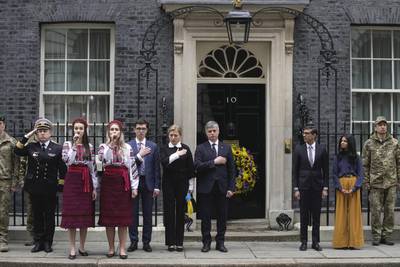 Britain's Prime Minister Rishi Sunak and his wife Akshata Murty, with Ukrainian ambassador to the UK Vadym Prystaiko, centre, his wife Inna and members of the Ukrainian Armed Forces outside 10 Downing Street in London, as they observe a minute's silence. AP