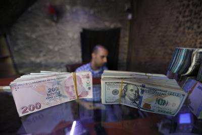 Banknotes of U.S. dollars and Turkish lira are seen in a currency exchange shop in the city of Azaz, Syria August 18, 2018. Picture taken August 18, 2018. REUTERS/Khalil Ashawi