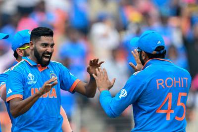 India's Mohammed Siraj celebrates with his captain Rohit Sharma after taking the wicket of Pakistan's Abdullah Shafique. AFP