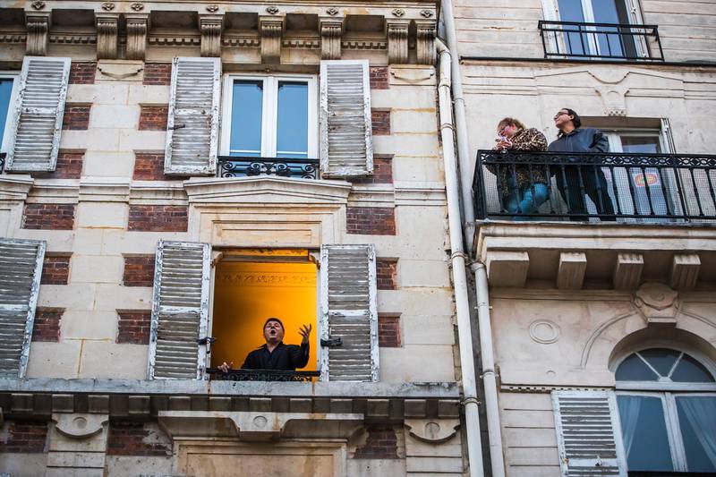 French tenor Stephane Senechal sings at his window for the inhabitants of his street in Paris, France.  EPA