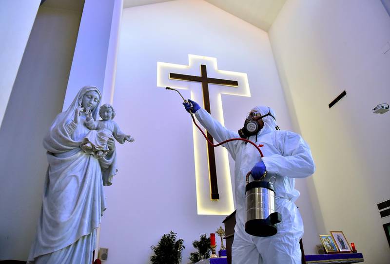Sanitary workers disinfect a church in Beirut. AFP