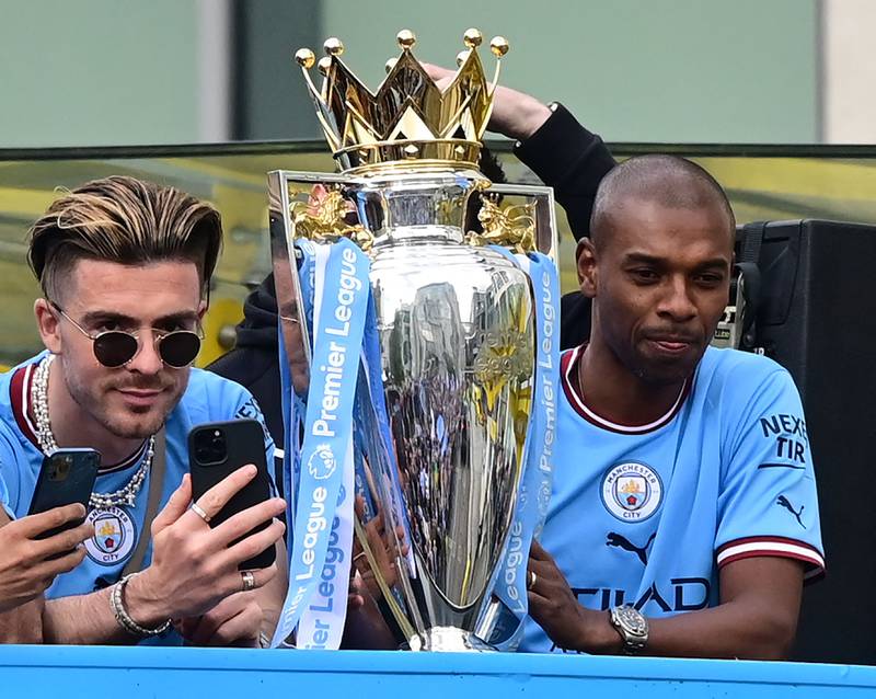 Jack Grealish and Fernandinho with the Premier League trophy. AFP