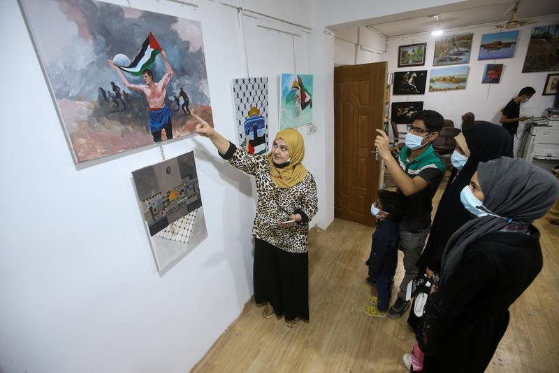 Visitors admire pro-Palestinian artworks at an art studio in Basra. Reuters
