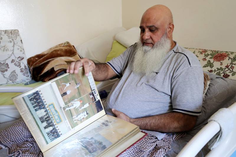 ABU DHABI,  UNITED ARAB EMIRATES , JUNE 17 – 2019 :- Mohammed Ishaq a player in the UAE's 1996 World Cup side, who is now wheelchair bound showing newspapers clipping at his home in Abu Dhabi. He is on wheelchair since a car crash in 2009. ( Pawan Singh / The National ) For Sport. Story by Paul