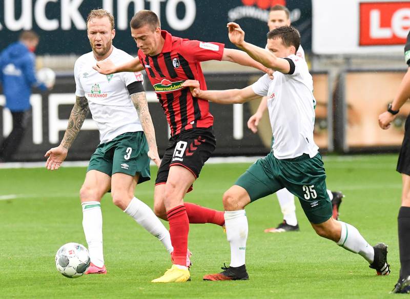 Freiburg midfielder Janik Haberer (C) and Bremen defender Kevin Vogt and midfielder Maximilian Eggestein vie for the ball. EPA