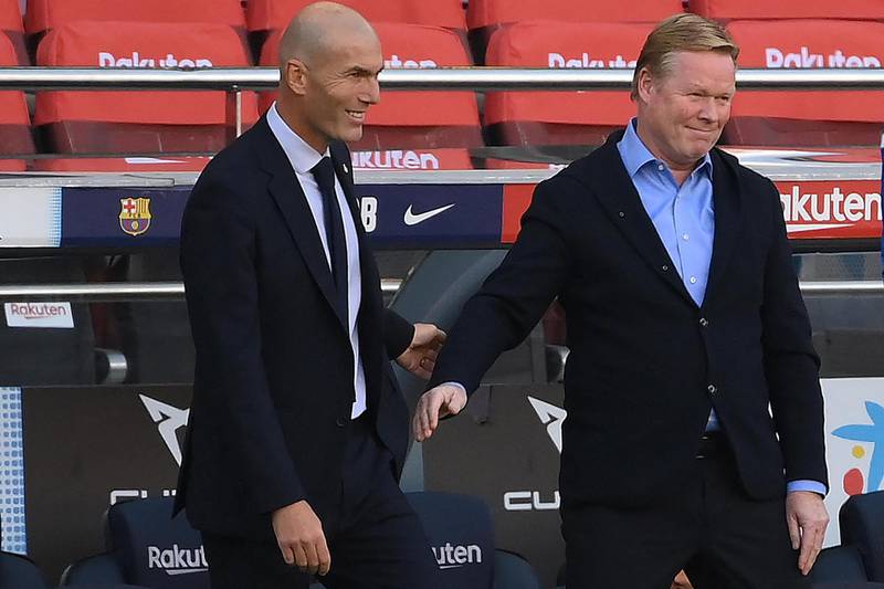 Real Madrid's French coach Zinedine Zidane (L) greets Barcelona's Dutch coach Ronald Koeman before the Spanish League football match between Barcelona and Real Madrid at the Camp Nou stadium in Barcelona on October 24, 2020. (Photo by LLUIS GENE / AFP)