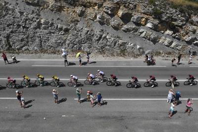 Fans cheer the peleton during the 16th stage on July 23, 2019. AFP