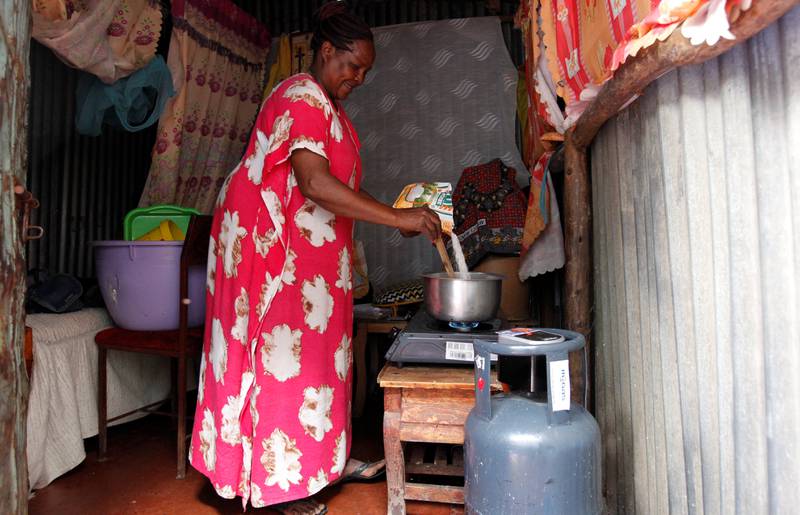 Regina Mutuku, 52, cooks using gas in her house in the Mukuru slum in Nairobi, Kenya. Reuters